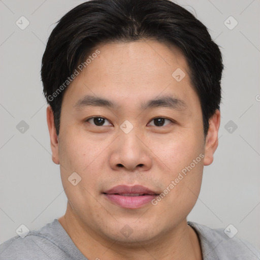 Joyful asian young-adult male with short  brown hair and brown eyes