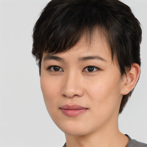 Joyful asian young-adult female with short  brown hair and brown eyes