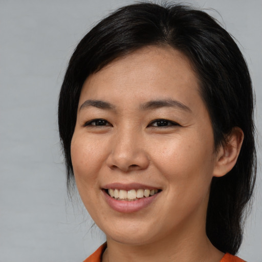 Joyful asian young-adult female with medium  black hair and brown eyes