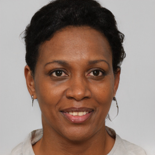 Joyful black adult female with short  brown hair and brown eyes