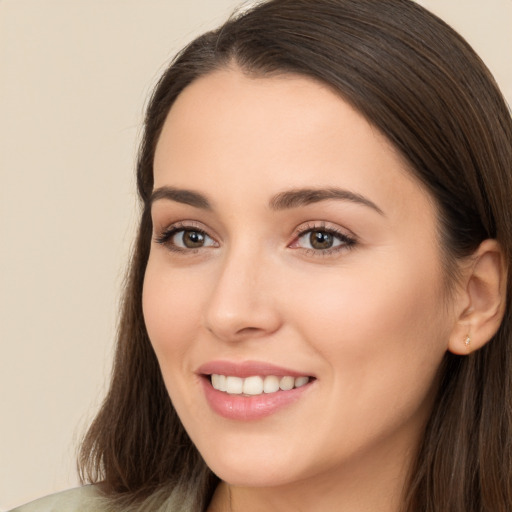 Joyful white young-adult female with long  brown hair and brown eyes