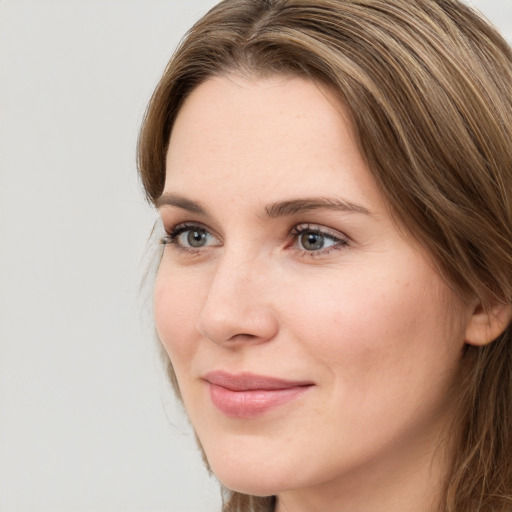 Joyful white young-adult female with long  brown hair and grey eyes