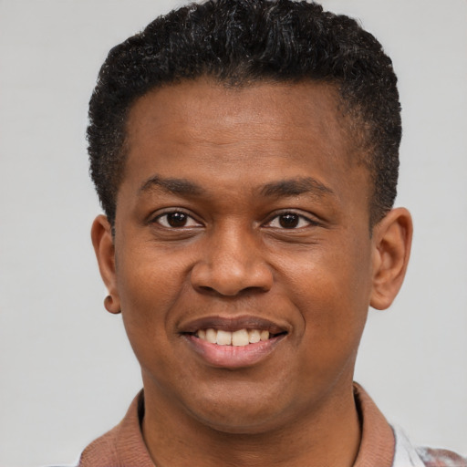 Joyful black young-adult male with short  brown hair and brown eyes