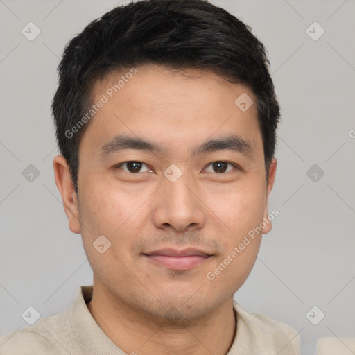 Joyful asian young-adult male with short  black hair and brown eyes