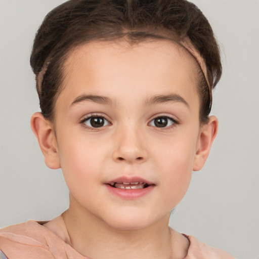 Joyful white child female with short  brown hair and brown eyes