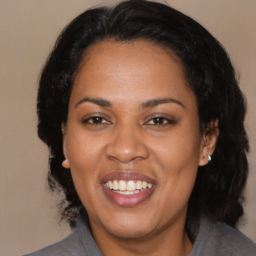 Joyful black adult female with medium  black hair and brown eyes