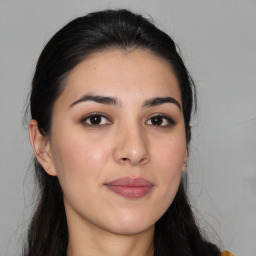 Joyful white young-adult female with long  brown hair and brown eyes