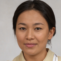 Joyful asian adult female with medium  brown hair and brown eyes