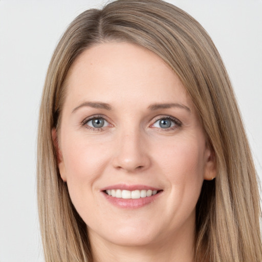 Joyful white young-adult female with long  brown hair and grey eyes