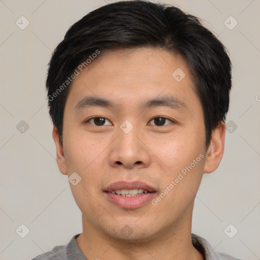 Joyful asian young-adult male with short  brown hair and brown eyes