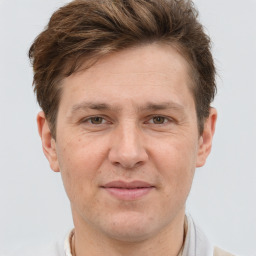 Joyful white adult male with short  brown hair and brown eyes