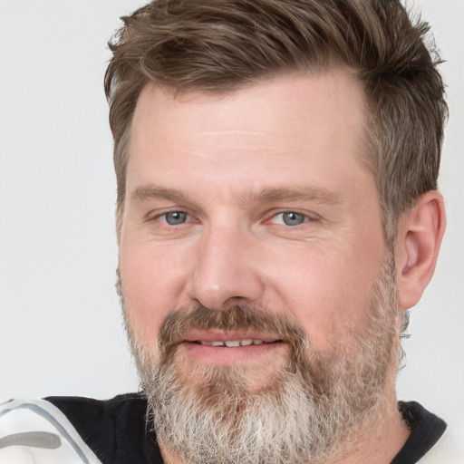 Joyful white adult male with short  brown hair and grey eyes