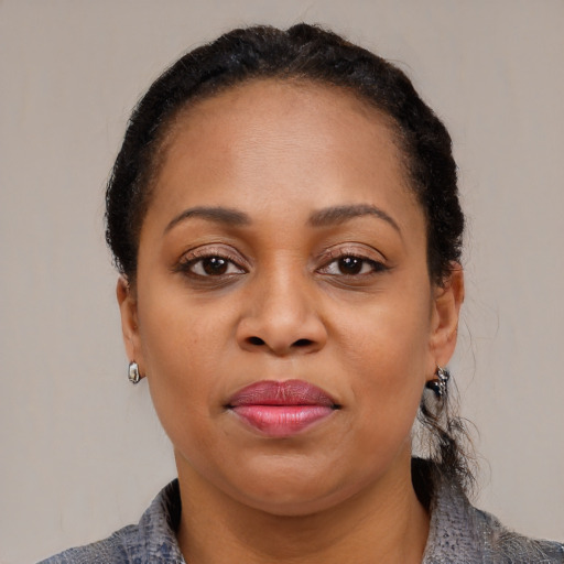 Joyful black young-adult female with medium  brown hair and brown eyes