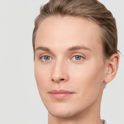 Joyful white young-adult male with short  brown hair and blue eyes