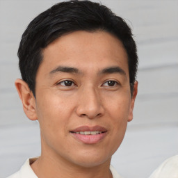 Joyful asian young-adult male with short  brown hair and brown eyes