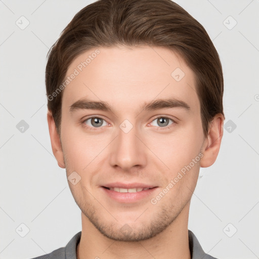 Joyful white young-adult male with short  brown hair and grey eyes