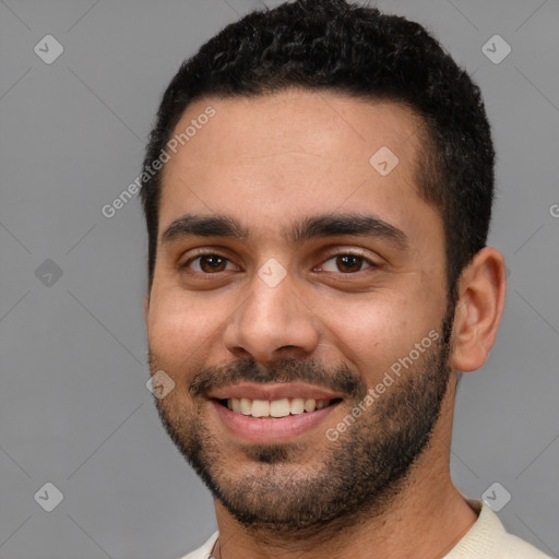 Joyful white young-adult male with short  black hair and brown eyes