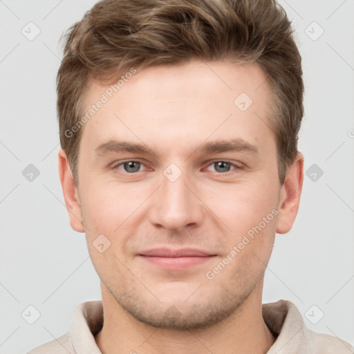 Joyful white young-adult male with short  brown hair and grey eyes