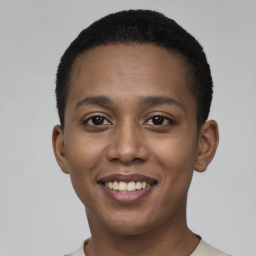 Joyful black young-adult female with short  black hair and brown eyes