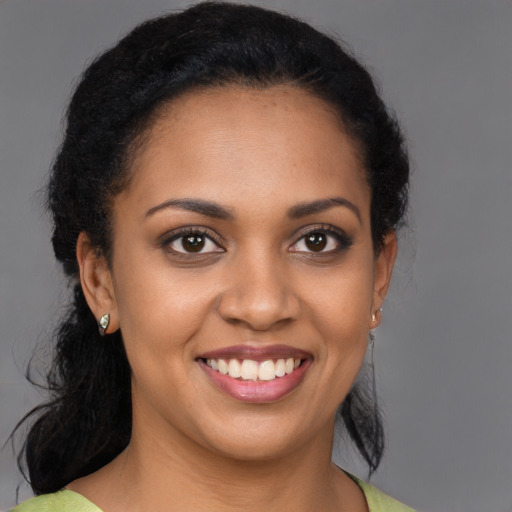 Joyful black young-adult female with medium  brown hair and brown eyes