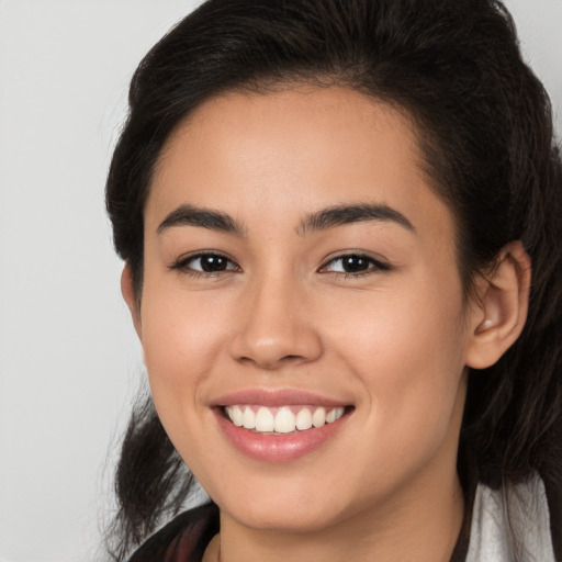 Joyful white young-adult female with long  brown hair and brown eyes