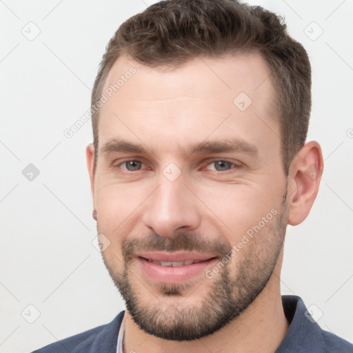 Joyful white young-adult male with short  brown hair and brown eyes