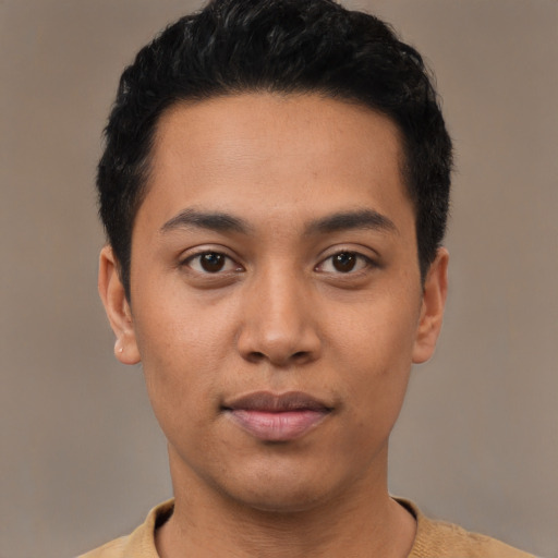 Joyful latino young-adult male with short  black hair and brown eyes