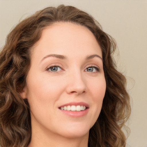 Joyful white young-adult female with long  brown hair and green eyes