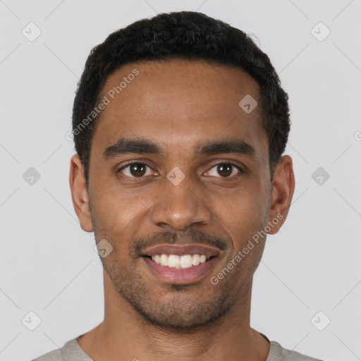 Joyful black young-adult male with short  black hair and brown eyes