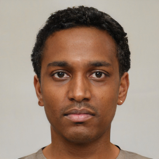 Neutral black young-adult male with short  black hair and brown eyes