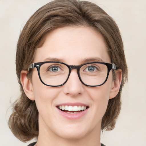 Joyful white young-adult female with medium  brown hair and green eyes