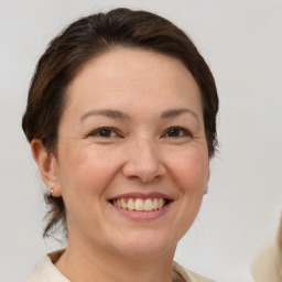 Joyful white adult female with medium  brown hair and brown eyes