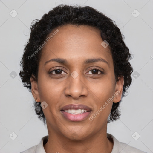 Joyful black adult female with short  brown hair and brown eyes