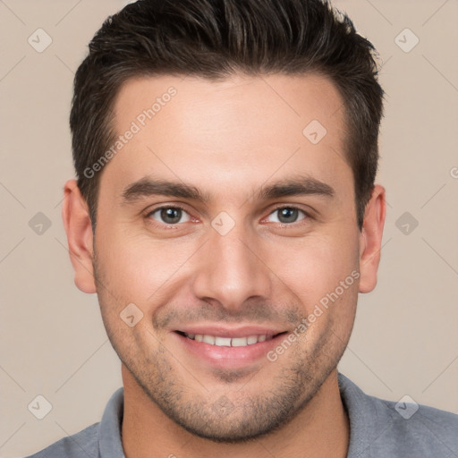 Joyful white young-adult male with short  brown hair and brown eyes