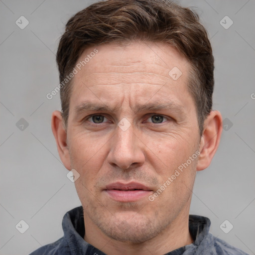 Joyful white adult male with short  brown hair and grey eyes