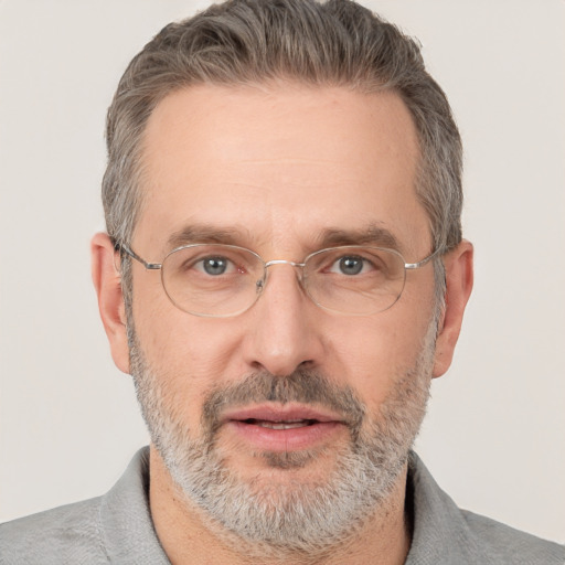 Joyful white adult male with short  gray hair and brown eyes