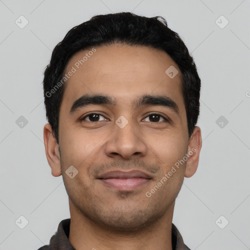 Joyful latino young-adult male with short  black hair and brown eyes