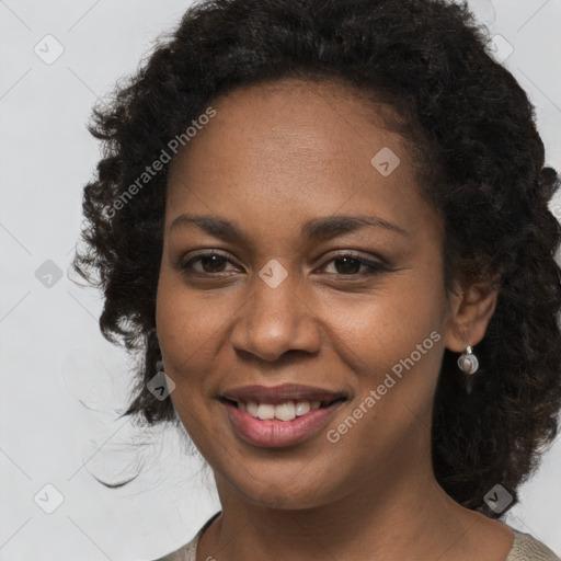 Joyful black young-adult female with long  brown hair and brown eyes