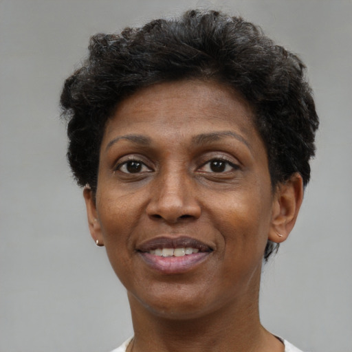 Joyful black adult female with short  brown hair and brown eyes