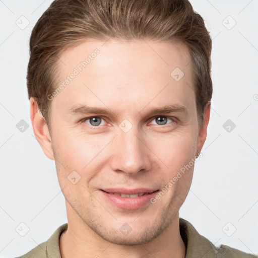 Joyful white young-adult male with short  brown hair and grey eyes