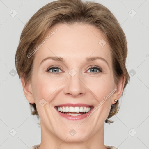 Joyful white adult female with medium  brown hair and grey eyes