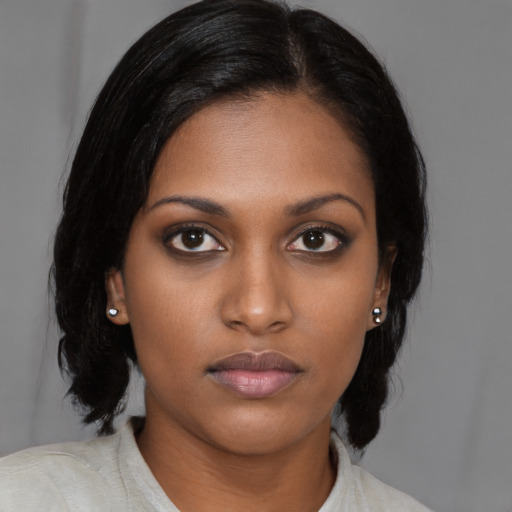 Neutral black young-adult female with medium  black hair and brown eyes