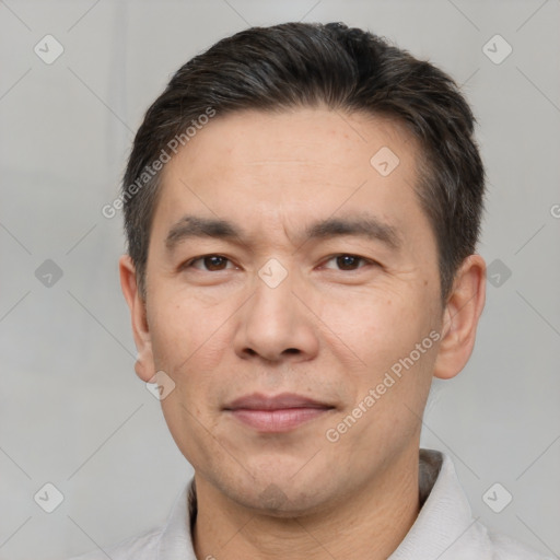 Joyful white adult male with short  black hair and brown eyes