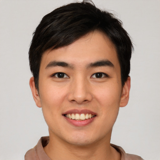 Joyful asian young-adult male with short  black hair and brown eyes