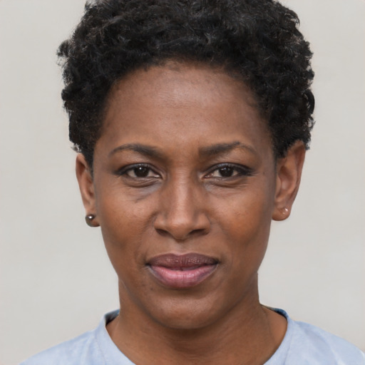 Joyful black adult female with short  black hair and brown eyes