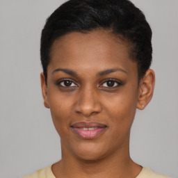 Joyful black young-adult female with short  black hair and brown eyes