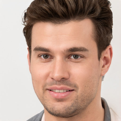 Joyful white young-adult male with short  brown hair and brown eyes