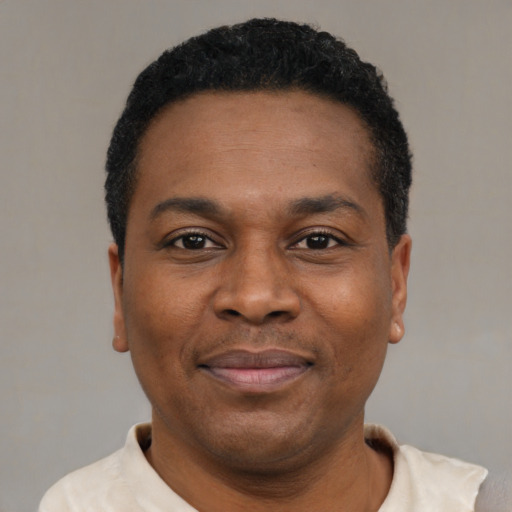 Joyful latino adult male with short  black hair and brown eyes
