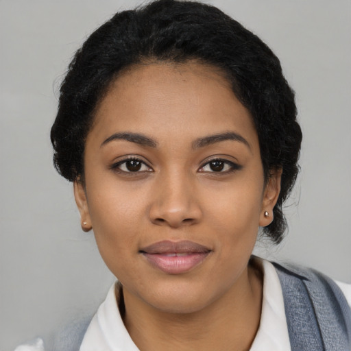 Joyful latino young-adult female with short  black hair and brown eyes