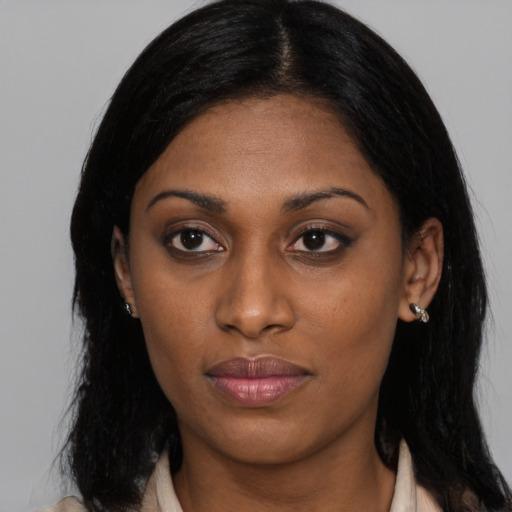 Joyful black young-adult female with medium  black hair and brown eyes